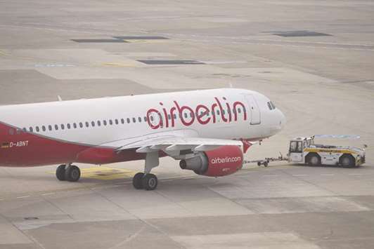 A tractor pulls an Air Berlin aircraft on the tarmac at Duesseldorf airport in Germany. The German federal authorities, along with the states of Berlin and North Rhine-Westphalia, are assessing Air Berlinu2019s request for financial guarantees, and a decision will come only after a thorough review of the airlineu2019s prospects, a ministry spokeswoman said.