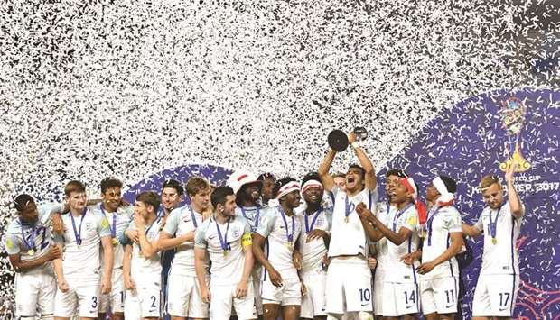 Englandu2019s players celebrate with the trophy during the awards ceremony after winning the U-20 World Cup final against Venezuela in Suwon. (AFP)