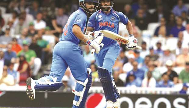 Indiau2019s Shikhar Dhawan (right) and Virat Kohli take a run during the ICC Champions Trophy match against South Africa at The Oval in London yesterday. (AFP)