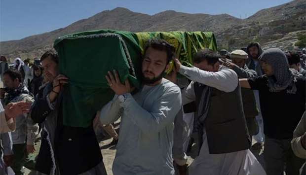 Afghan mourners carry the coffin of one of the victims killed in Kabul, on Thursday.
