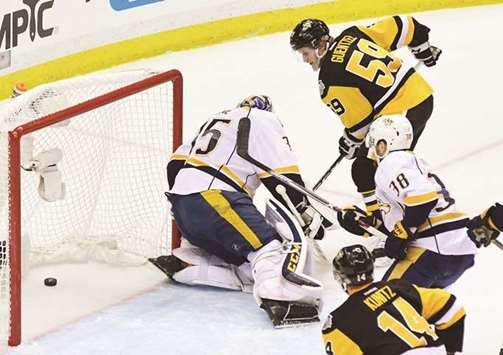 Pittsburgh Penguinsu2019 Jake Guentzel (top right) scores past Nashville Predatorsu2019 Pekka Rinne during the Game Two of the 2017 NHL Stanley Cup Final in Pittsburgh, Pennsylvania. (AFP)