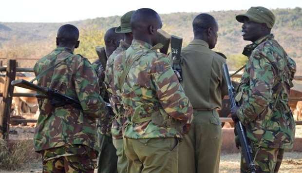 Kenya police officers gather near the site