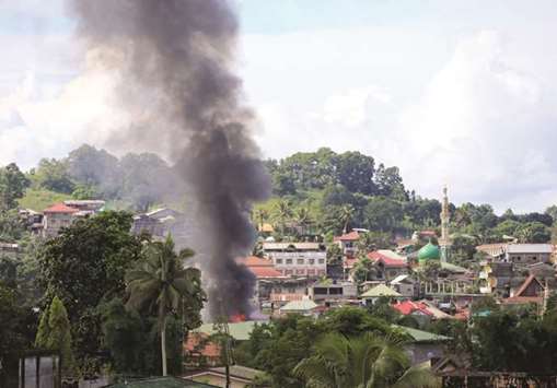 Smoke billowing from a burning building is seen as government troops continue their assault on insurgents from the Maute group.