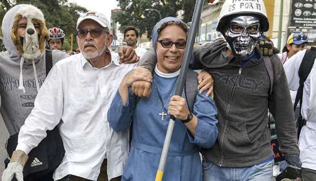 A nun and other demonstrators take part in the protest against the Maduro government in Caracas on Saturday.