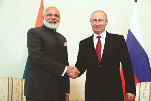 Russian President Vladimir Putin shakes hands with Prime Minister Narendra Modi during a meeting on the sidelines of the St Petersburg International Economic Forum (SPIEF) in Saint Petersburg yesterday.