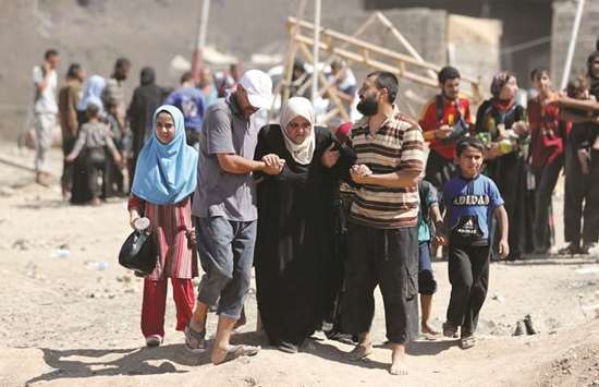 Displaced Iraqis evacuate their home in western Mosulu2019s Zanjili neighbourhood yesterday.