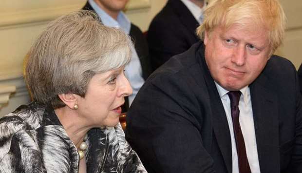 Britain's Prime Minister Theresa May sits next to Britain's Foreign Secretary Boris Johnson as she holds the first Cabinet meeting following the general election at 10 Downing Street, in London.