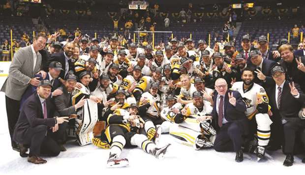 Pittsburgh Penguins players and officials pose with the Stanley Cup trophy after they defeated Nashville Predators 2-0 in the Game Six of the NHL Stanley Cup Final in Nashville, Tennessee on Sunday. (AFP)