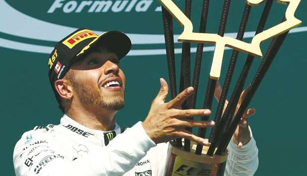Mercedes driver Lewis Hamilton celebrates on the podium after winning the Canadian Formula One Grand Prix at Circuit Gilles Villeneuve in Montreal. (Getty Images/AFP)