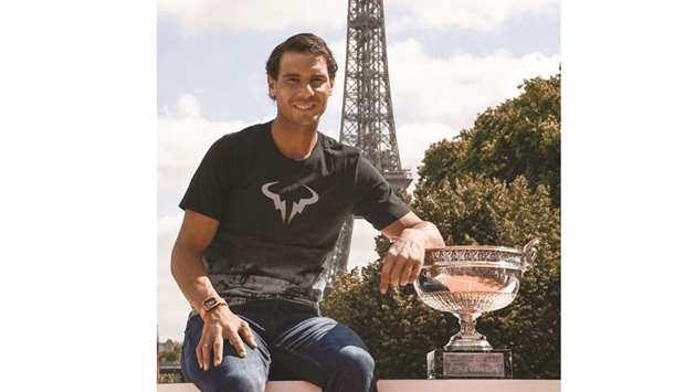 Spainu2019s Rafael Nadal poses with the French Open trophy in Paris. (AFP)