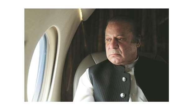 Pakistani Prime Minister Nawaz Sharif looks out the window of his plane after attending a ceremony to inaugurate the M9 motorway between Karachi and Hyderabad. Picture taken February 3.