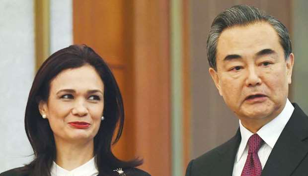 Panamau2019s Vice President and Foreign Minister Isabel de Saint Malo (left) and Chinese Foreign Minister Wang Yi chat during a ceremony on establishing diplomatic relations, in Beijing yesterday.