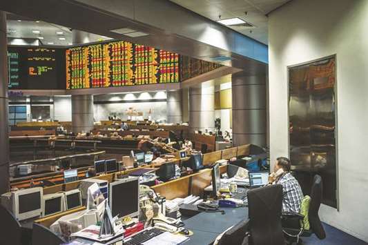 Traders and stock owners are seen on the floor of the RHB Investment Bank in Kuala Lumpur. With Malaysiau2019s stocks near a two-year high, one top fund manager expects the market to stop and catch its breath before taking another leg higher on Chinese investment and improvement in corporate earnings.