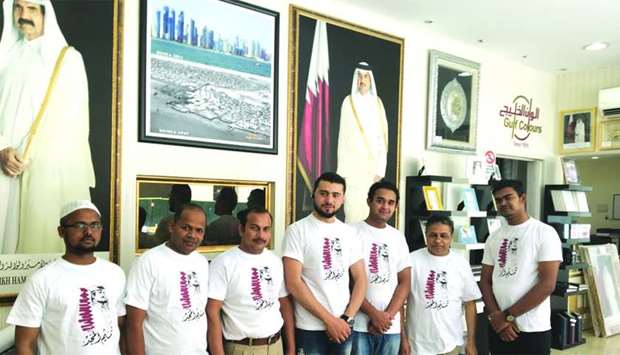 Employees of a private firm wearing T-shirts supporting Qatar.