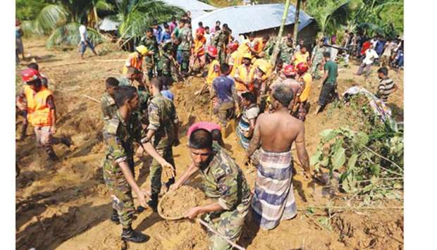 Army and firefighters work to remove debris as they search for bodies after a landslide in Rangamati yesterday.