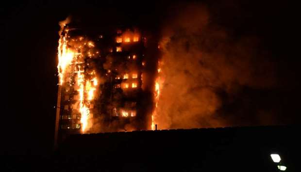Flames engulfing a 27-storey block of flats in west London. Picture taken by local resident Giulio Thuburn.  AFP
