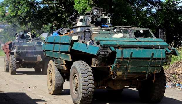 An Armoured Personnel Carrier (APC) moves along a road at Amai Pakpak as government troops continue their assault against insurgents from the Maute group, who have taken over large parts of Marawi City, Philippines.