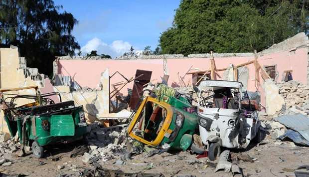 Damaged vehicles are seen at the scene of an attack outside a hotel and an adjacent restaurant in Mogadishu, Somalia.