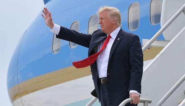 President Donald Trump steps off Air Force One upon arrival at Miami International Airport in Miami on Friday.
