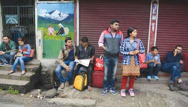 Stranded tourists wait for transportation during a strike called by the Gorkha Janmukti Morcha (GJM) in Darjeeling yesterday.