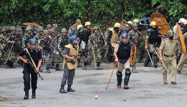 Indian CRPF personnel walk during clashes in Darjeeling