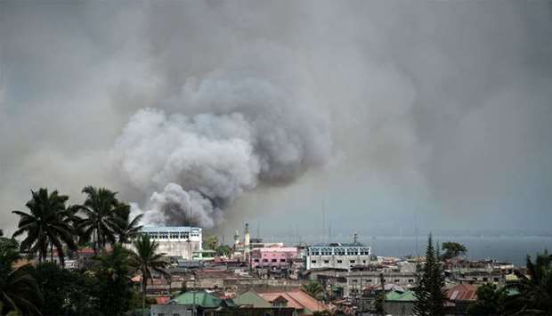 Smoke rises after aerial bombings by Philippine Air Force planes on militant positions in Marawi