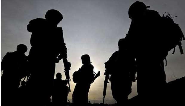 US soldiers with the NATO-led International Security Assistance Force (ISAF) silhouetted as they walk during a patrol outside Bagram Airbase, some 50 km north of Kabul. February 28, 2009 file picture.