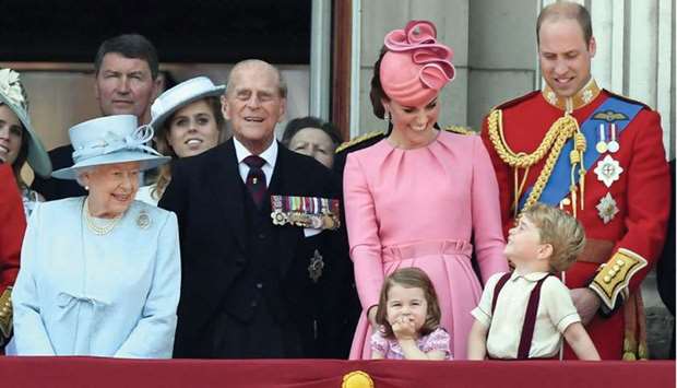Members of the Royal Family: Queen Elizabeth II, Vice Admiral Timothy Laurence, Princess Beatrice of York, Prince Philip, Duke of Edinburgh, Catherine, Duchess of Cambridge (with Princess Charlotte and Prince George), and Prince William, Duke of Cambridge, stand on the balcony of Buckingham Palace to watch a fly-past of aircraft by the Royal Air Force, in London.
