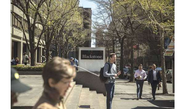 Pedestrians pass in front of Blackstone Group headquarters in New York. Blackstone, the  largest manager of alternative assets, is the worldu2019s biggest real estate investor, with $102bn under management in the sector as of March 31.