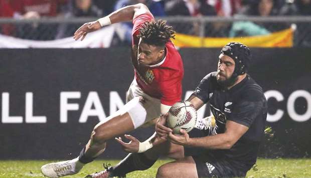 Anthony Watson of the British and Irish Lions (L) and Charlie Ngatai of the Maori All Blacks compete for the ball during their international rugby match at Rotorua International Stadium in Rotorua yesterday. (AFP)