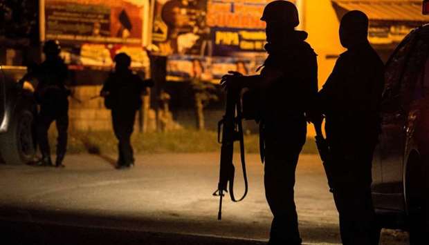 Philippine members of Special Weapons and Tactics  patrol the area