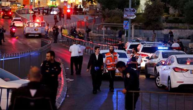 Israeli policemen secure the scene of the shooting and stabbing attack outside Damascus gate in Jeru