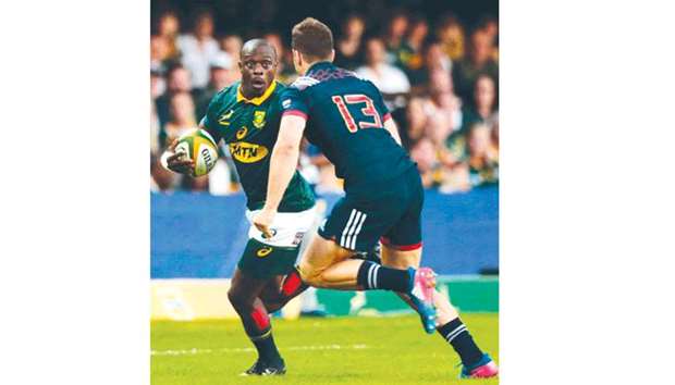 Oupa Mohoje of South Africa (left) avoids a tackle during the Test against France in Durban. (AFP)