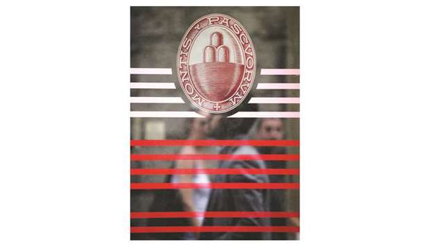 A logo is seen on the door of a Monte dei Paschi branch in Siena. Fortress and Elliott were the only international bidders for the riskiest tranches of Monte Paschiu2019s debt securitisation, backed by loans with a face value of about u20ac26bn ($29bn), sources said.