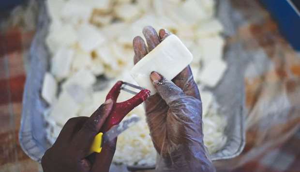 An Anacaona staffer cleans used soap collected from a hotel in Port-au-Prince.