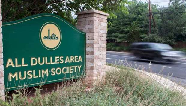 A car drives past the entrance to the All Dulles Area Muslim Society in Sterling, Virginia on Monday.