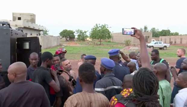 Police with four people rescued from the Le Campement Kangaba resort following an attack where gunmen stormed the resort in Dougourakoro, to the east of the capital Bamako, Mali in this still frame taken from video.