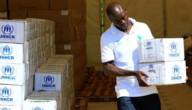 A social worker arranges emergency utensil boxes at the United Nations High Commissioner for Refugees (UNHCR) store, for distribution to South Sudanese refugees, arriving at the Palabek Refugee Settlement Camp in Lamwo district, Uganda.