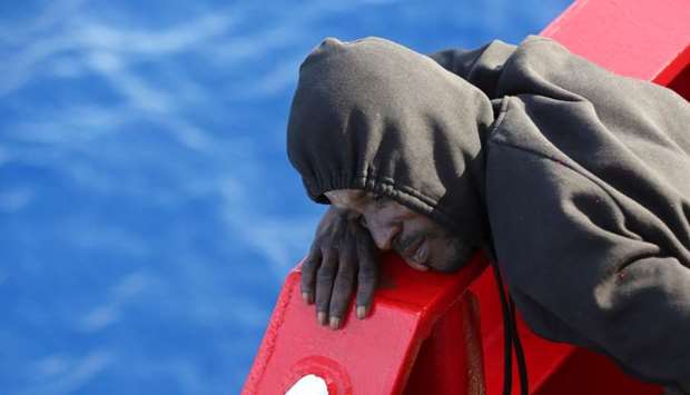 A migrant rests on the Vos Hestia ship after being rescued by the ,Save the Children, NGO crew in the Mediterranean sea off the Libya coast.