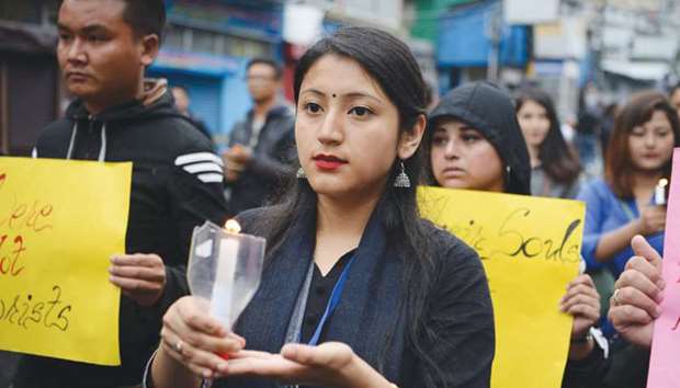 Students supporters of Gorkha Janmukti Morcha (GJM) hold candles as they take part in a peace march as well as to pay respect to those killed in clashes with police during an indefinite strike called by the GJM, in Darjeeling, yesterday.