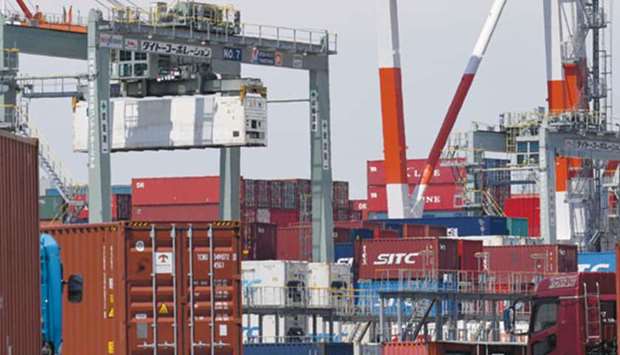Trailers move into the international container yard at a pier in Tokyo port. Japan logged a surprise deficit of u00a5203bn ($1.8bn), the first red ink in four months despite market expectations for a surplus, according to data from the finance ministry.