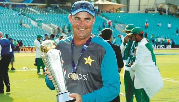 Pakistanu2019s coach Mickey Arthur poses for a photograph with the trophy after the ICC Champions Trophy final match. (AFP)