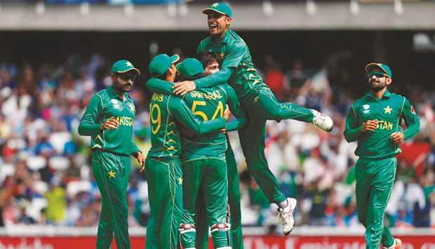 Pakistanu2019s Mohamed Amir celebrates with teammates after taking the wicket of Indiau2019s Shikhar Dhawan for 21 during the ICC Champions Trophy final cricket match between India and Pakistan at The Oval in London on Sunday.  (AFP)