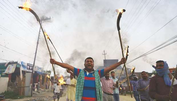 Nepali Madhesi protesters, a marginalised group in the southern plains, shout slogans during a torch rally in Janakpur, as they protest against forthcoming local elections.