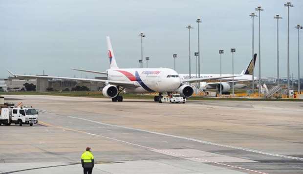 Armed police stormed a Malaysia Airlines flight which was forced to return to Melbourne after a passenger tried to enter the cockpit
