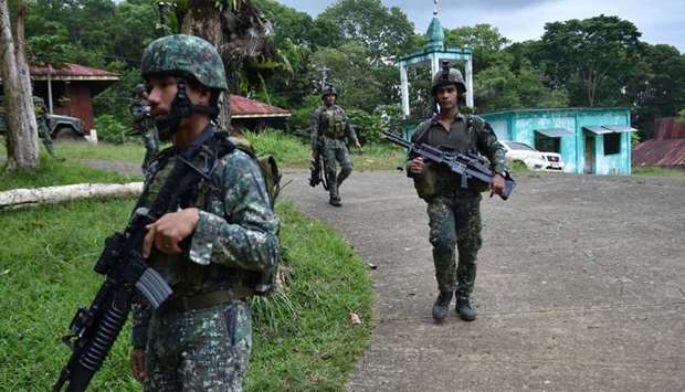 Philippine Marines patrol a walkway after engaging with militants in Marawi