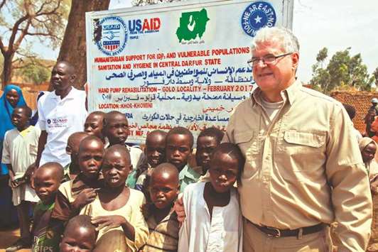 Steven Koutsis (right), the United Statesu2019 top envoy in Sudan, poses for a picture with Sudanese children and villagers in the town of Golo in the thickly forested mountainous area of Jebel Marra in central Darfur yesterday.