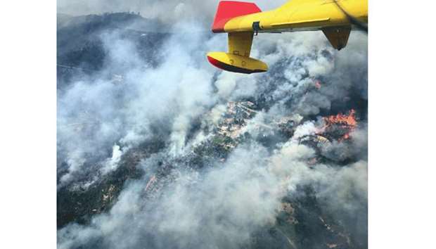 Aerial view of a forest fire is seen from the cabin of a Spanish 43 Grupo firefighting plane near Pedrogao Grande.