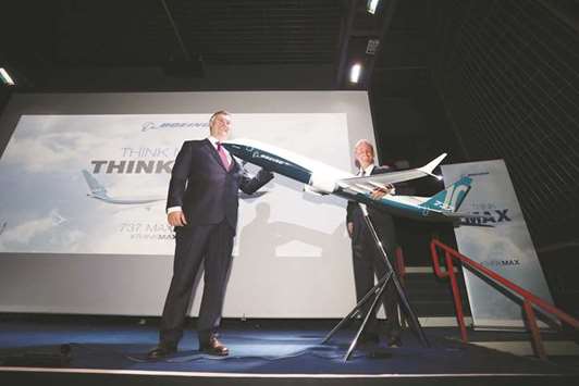 Boeing officials pose beside a model of a Boeing 737 Max 10 passenger jet during a news conference at the 53rd International Paris Air Show at Le Bourget in Paris on Monday. United Airlines, which will become the largest single 737 MAX 10 customer in the world, said it expected the delivery of the first of the planes in late 2020.