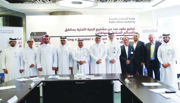 Ashghal president Saad bin Ahmed al-Muhannadi, Kahramaa president Issa bin Hilal al-Kuwari, Ashghal vice president Abdulla Hamad al-Attiyah and Infrastructure Affairs director Mohamed Masoud al-Marri and other Ashghal officials with officials of companies which were awarded contracts. PICTURE: Jayaram.